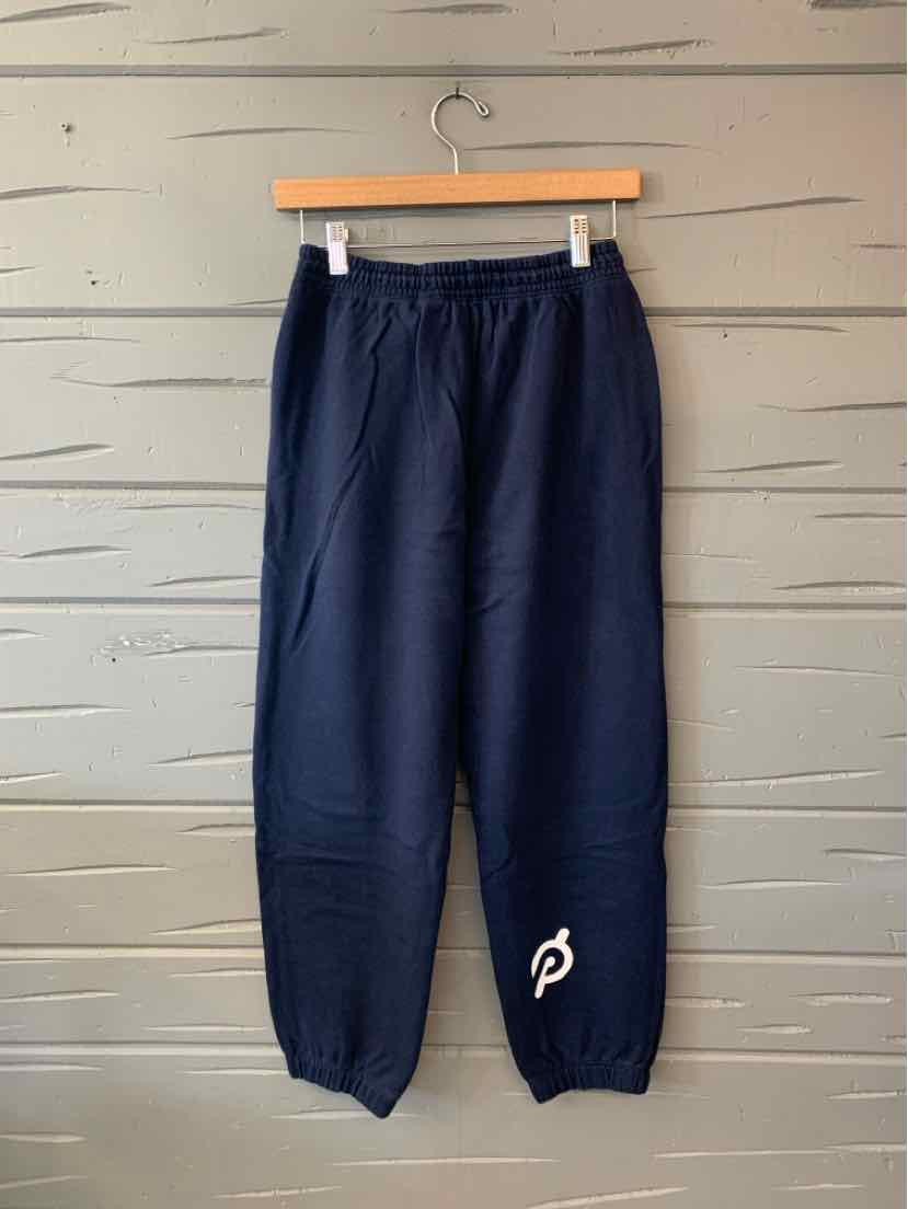 Navy blue pants with an elastic waistband, tapered legs, and a small white logo near the ankle.