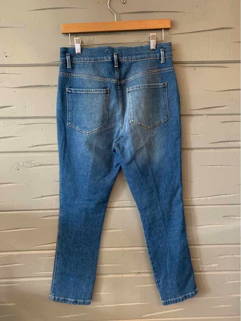 Blue denim jeans with straight legs, visible back pockets, and belt loops hanging on wooden hanger.