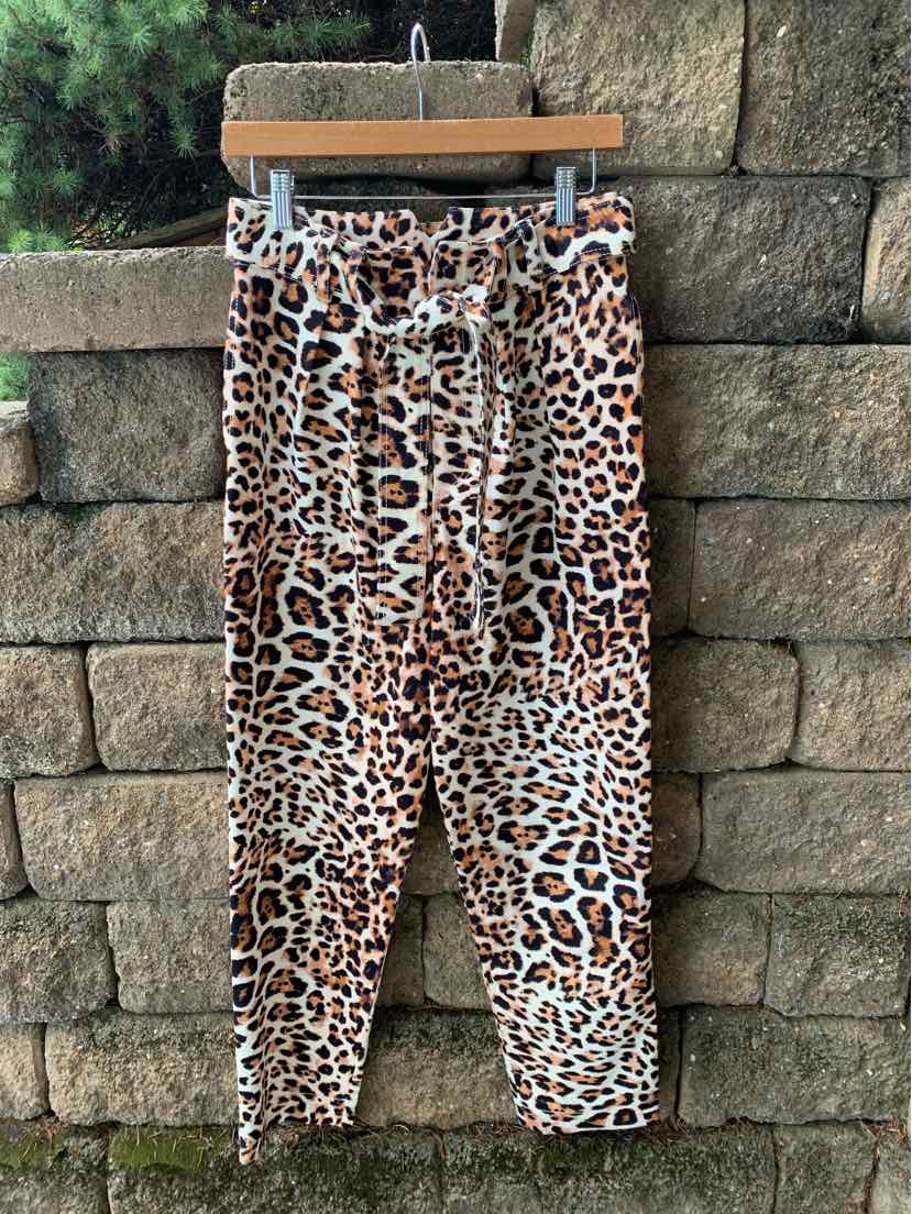 Tan and brown cheetah print jogger pants with elastic waistband and drawstring, tapered legs.