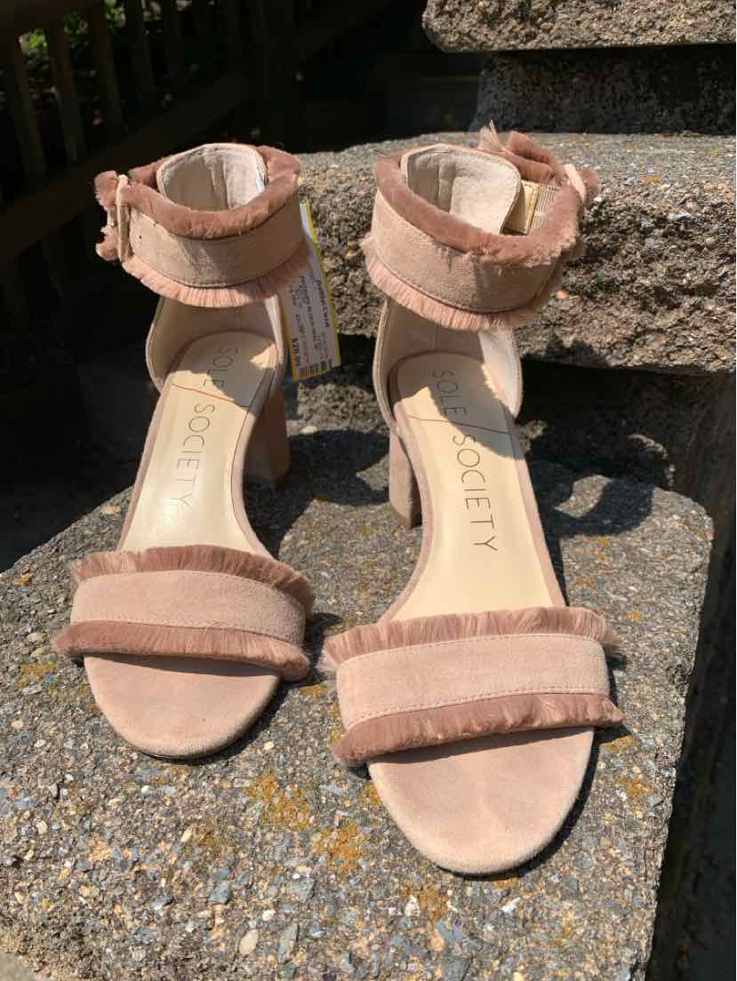 Taupe suede open-toe heels with ankle straps and fringe detail on front and ankle bands.