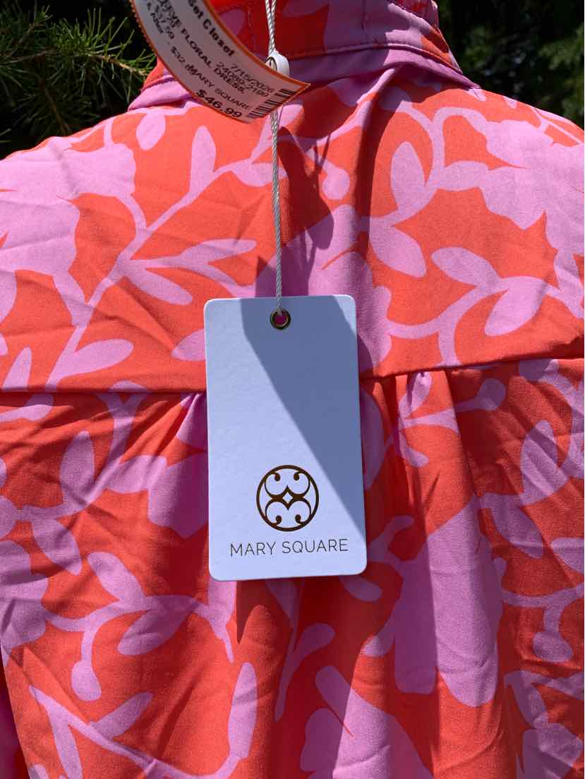 Pink dress with bold coral floral pattern and gathered detail beneath the neckline, featuring a white Mary Square tag.