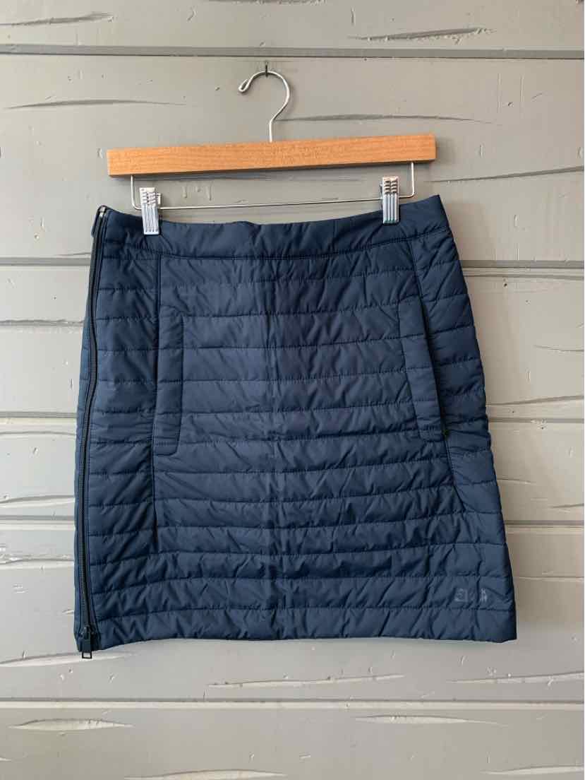 Navy blue quilted insulated skirt with horizontal stitching and side zipper details.