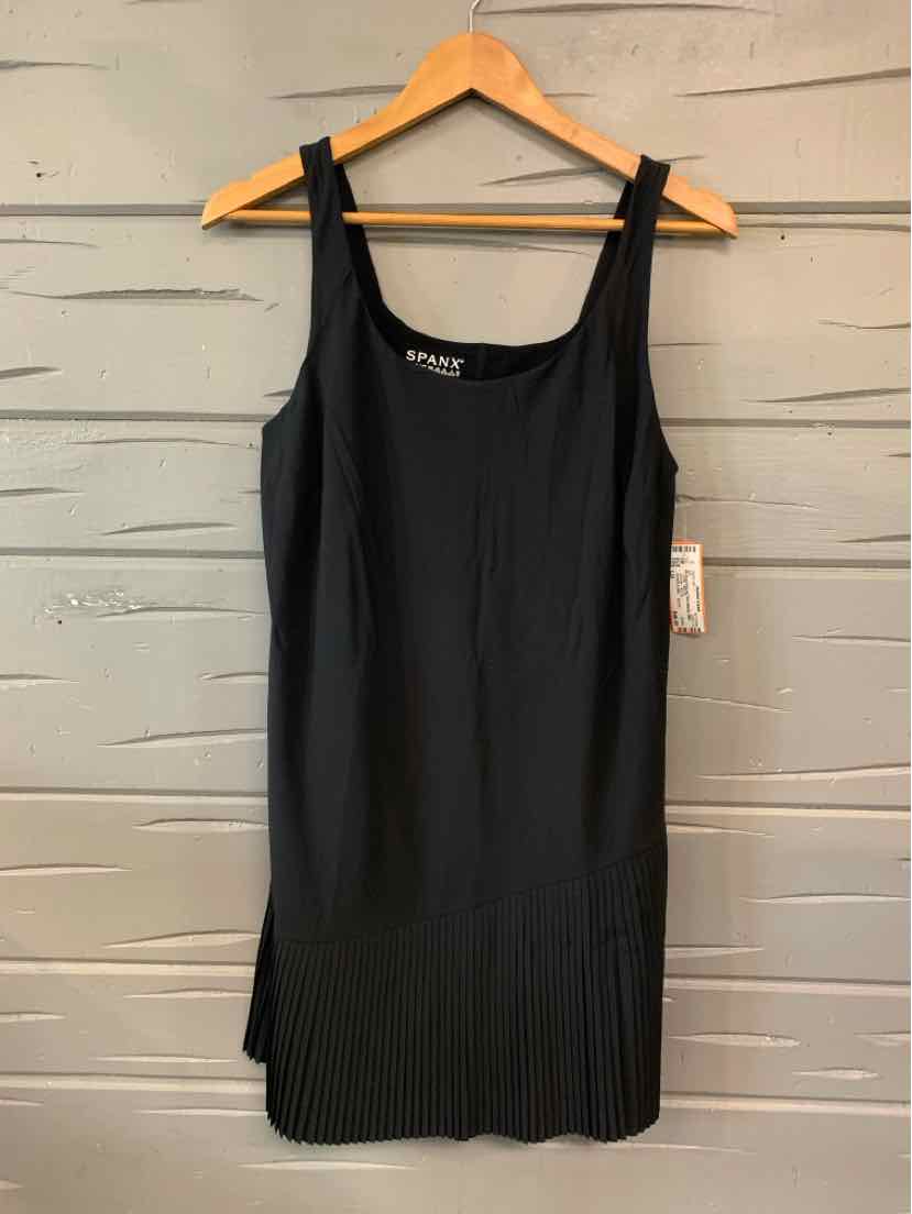 Black sleeveless ribbed tank dress with square neckline hanging on wooden hanger.