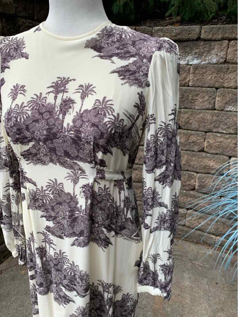 Cream dress with long puff sleeves and purple toile floral print, fitted waist.