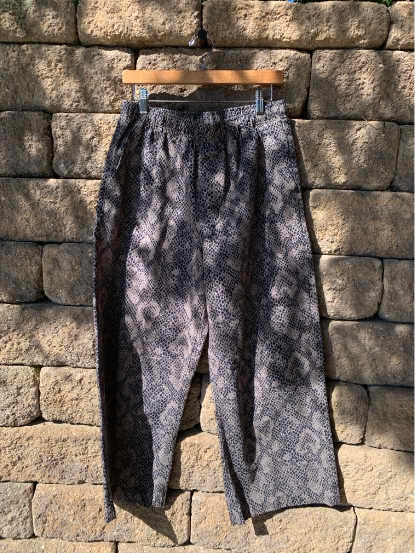 Gray tapered pants with subtle animal print, elastic waistband, and relaxed fit in medium size.