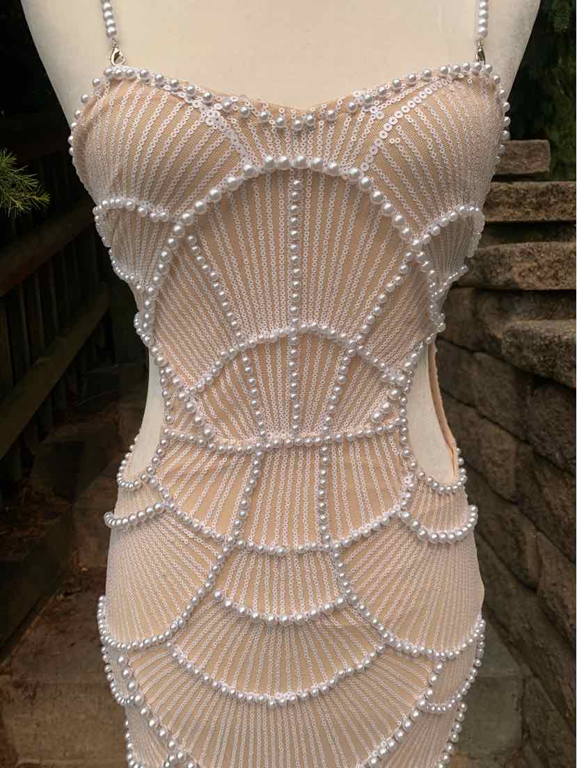 Tan fitted dress with intricate pearl bead scallop patterns and thin spaghetti straps.