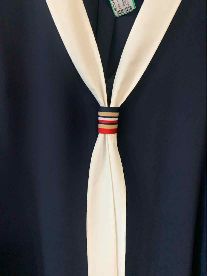 Navy blue Tommy Hilfiger top with white scarf and red, white, and navy striped detail.