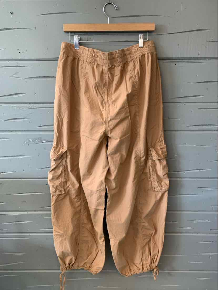 Tan cargo pants with elastic waistband, multiple pockets, and gathered elastic cuffs.