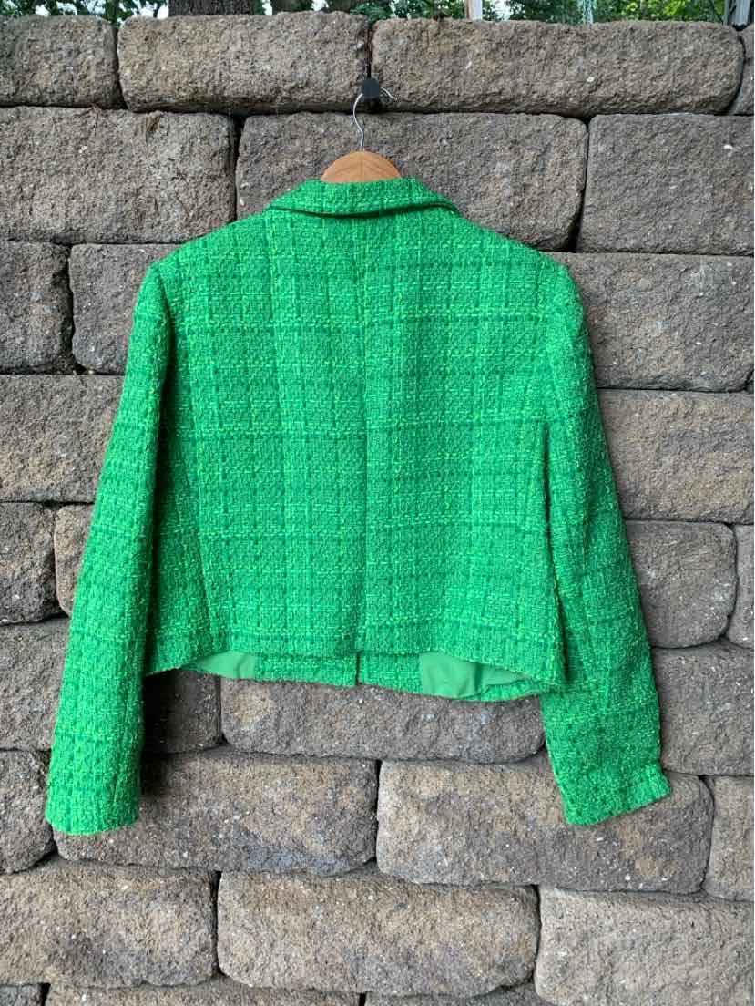 Green tweed cropped blazer with long sleeves and structured shoulders.
