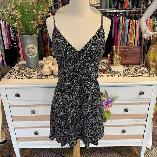 Black floral spaghetti strap dress with V-neck and flared skirt on mannequin.