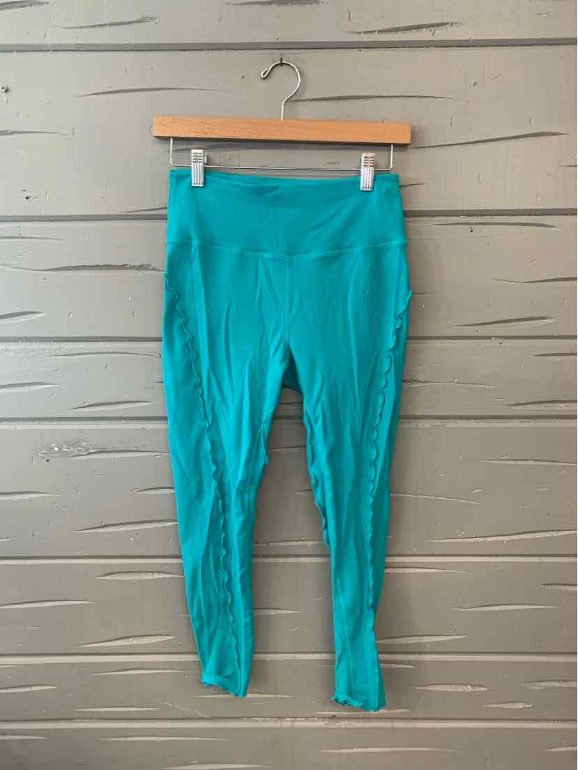 Teal high-waisted workout leggings with smooth, stretchy fabric and no visible logos.