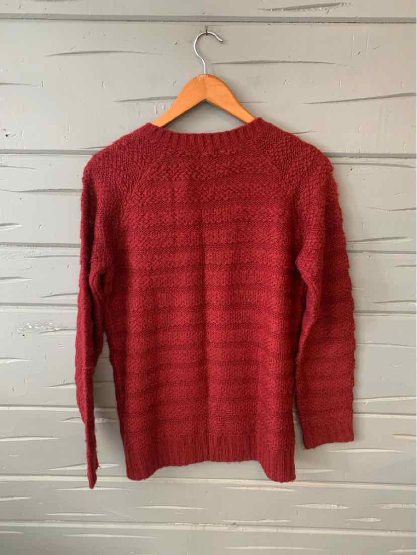 Burgundy knit sweater with textured horizontal stripes and long sleeves on wooden hanger.