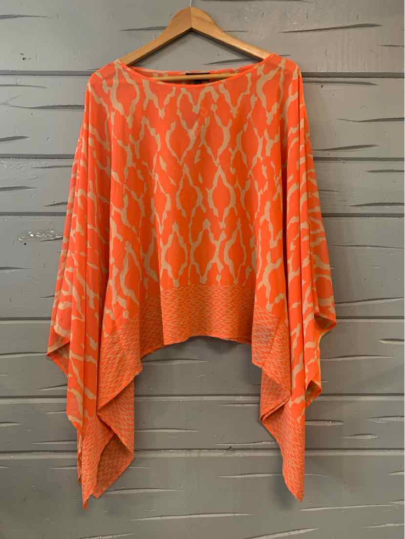 Orange oversized knit sweater with animal print and asymmetrical hem on wooden hanger.