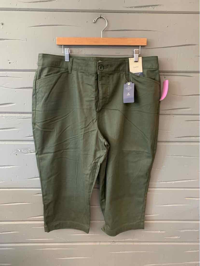 Olive green women's cropped pants with front pockets and button closure on wooden hanger.