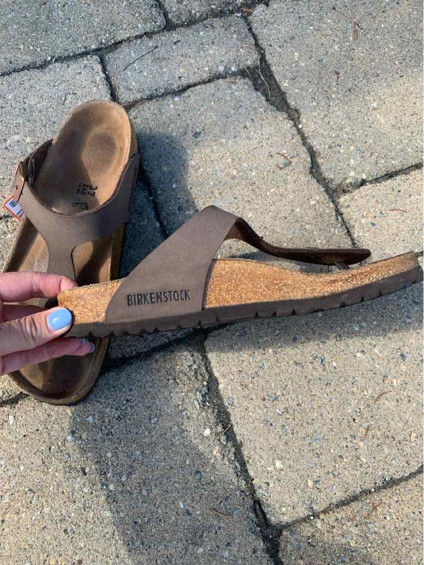 Brown leather Birkenstock sandal with cork sole and adjustable strap, size 37.