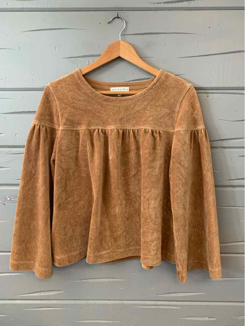 Tan long-sleeve textured top with gathered yoke detail and relaxed fit, size medium.