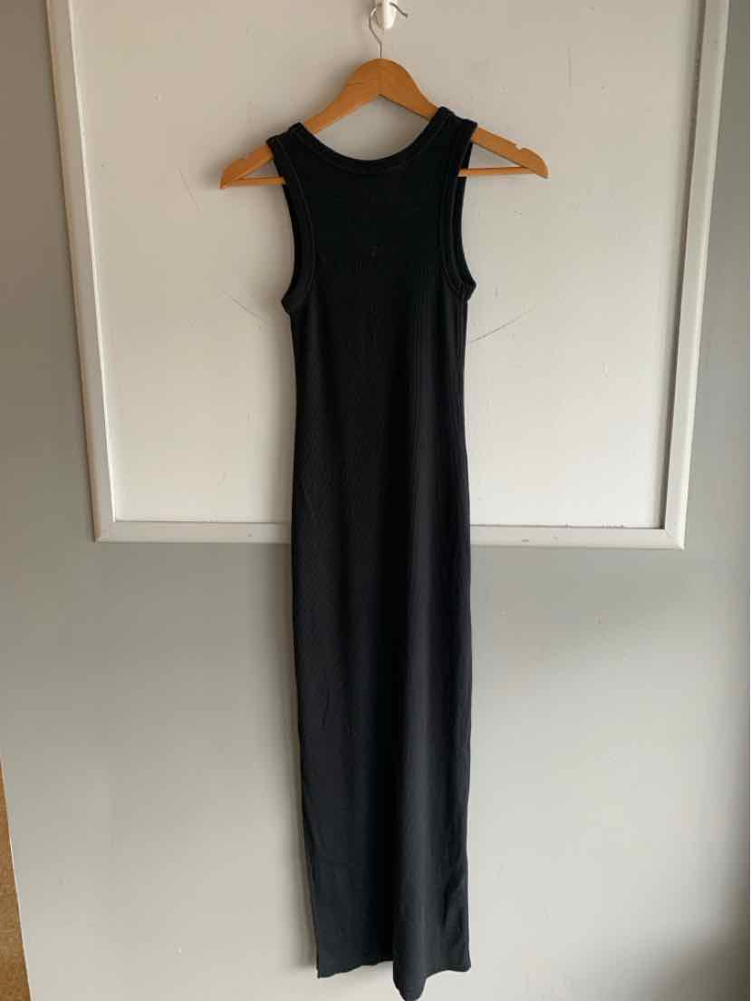 Black sleeveless fitted midi dress with high neckline and straight hem on wooden hanger.