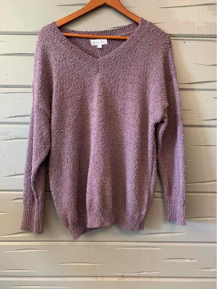 Mauve women's casual top with soft knit fabric and V-neck on wooden hanger.