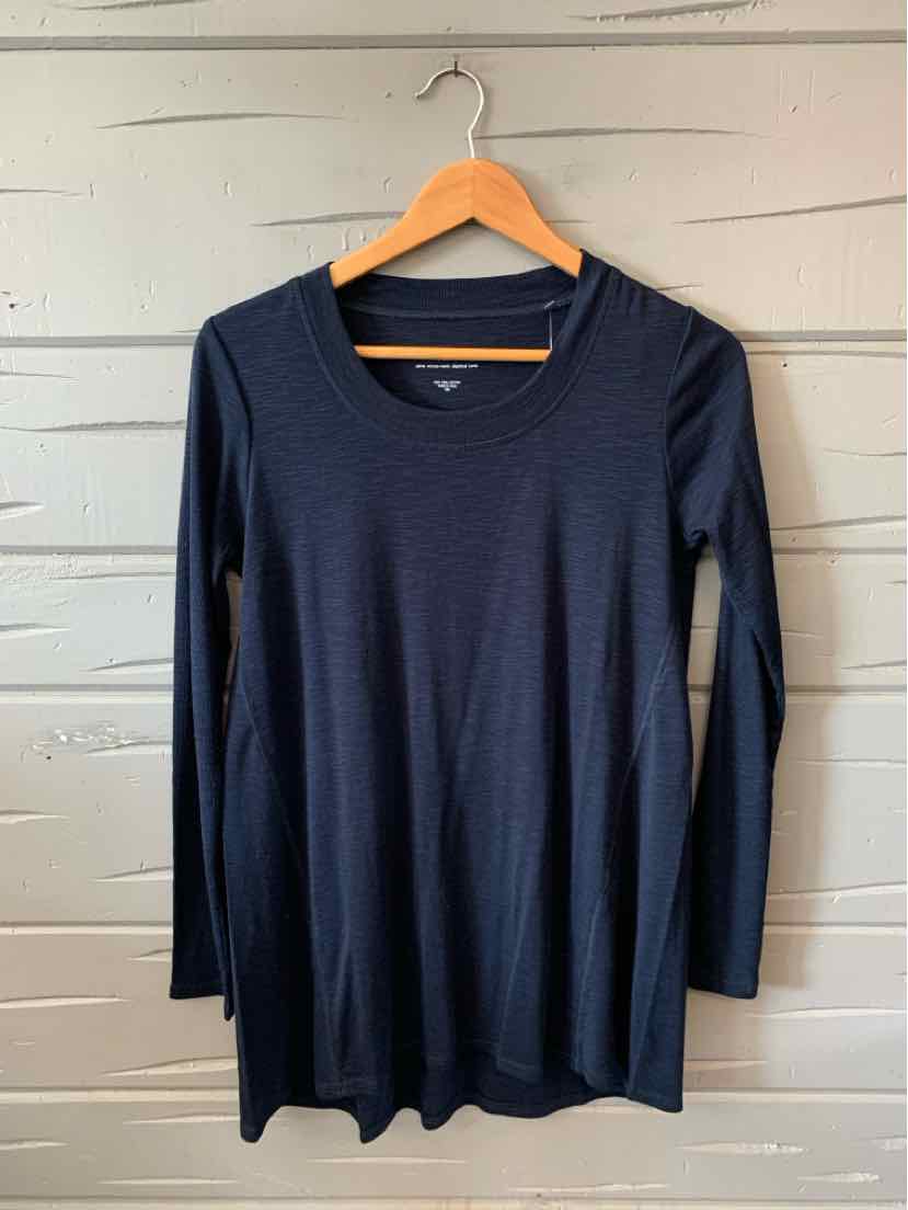 Navy blue long-sleeve scoop neck top in lightweight knit fabric hanging on a wooden hanger.