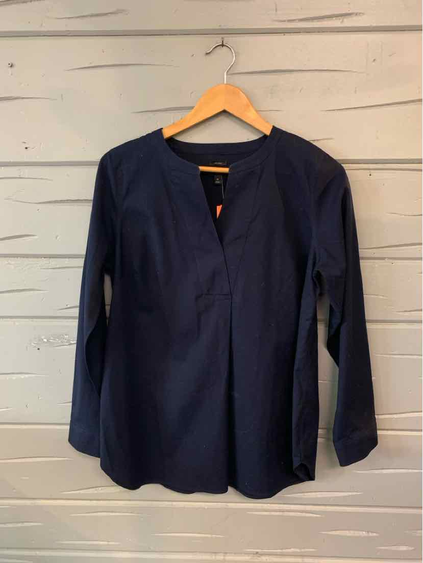 Navy blue long-sleeve blouse with V-neck and lightweight fabric hanging on wooden hanger.