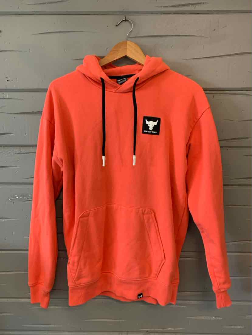 Coral hoodie with black drawstrings, kangaroo pocket, and small black logo patch on chest.