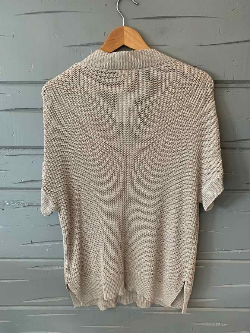 Taupe short-sleeve knit sweater with ribbed texture and side slits on a wooden hanger.