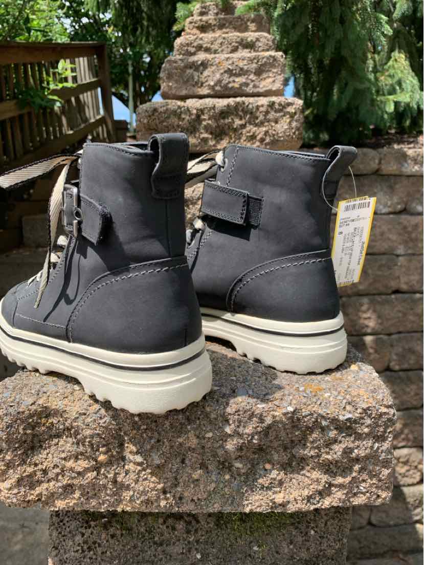 Black ankle boots with chunky white soles, suede material, strap and buckle detail, size 8.