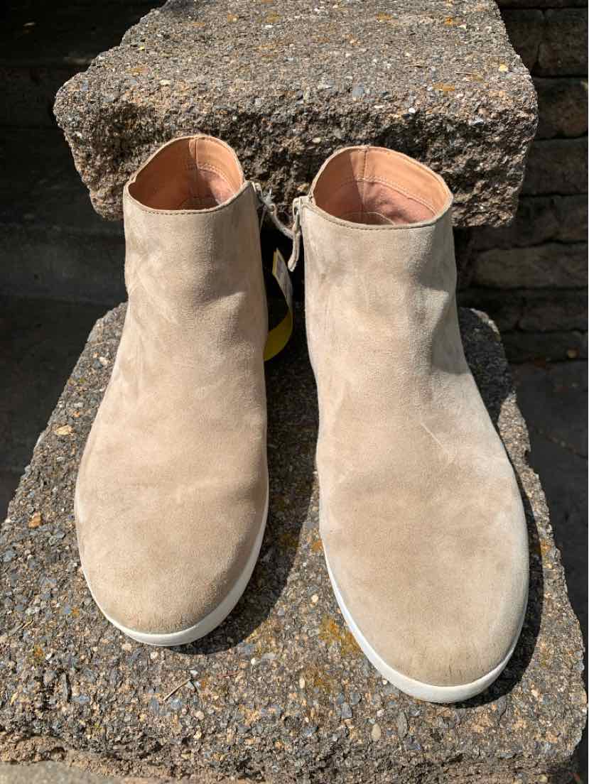 Beige suede ankle boots with round toes and white soles, size 10.