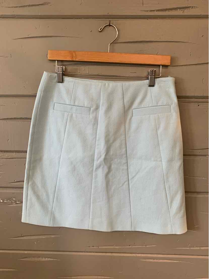 Light blue solid mini skirt with front seams and two front welt pockets, size 4.