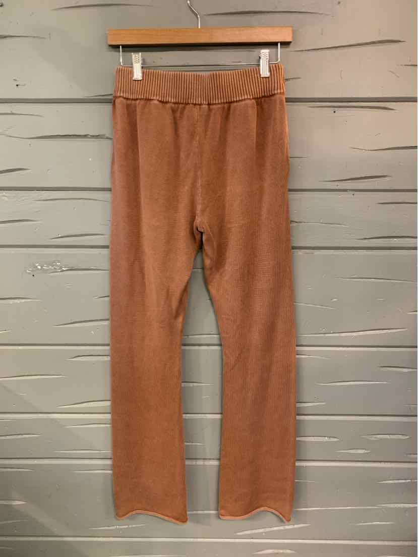 Tan ribbed knit pants with a fitted elastic waistband and straight legs in size XS.