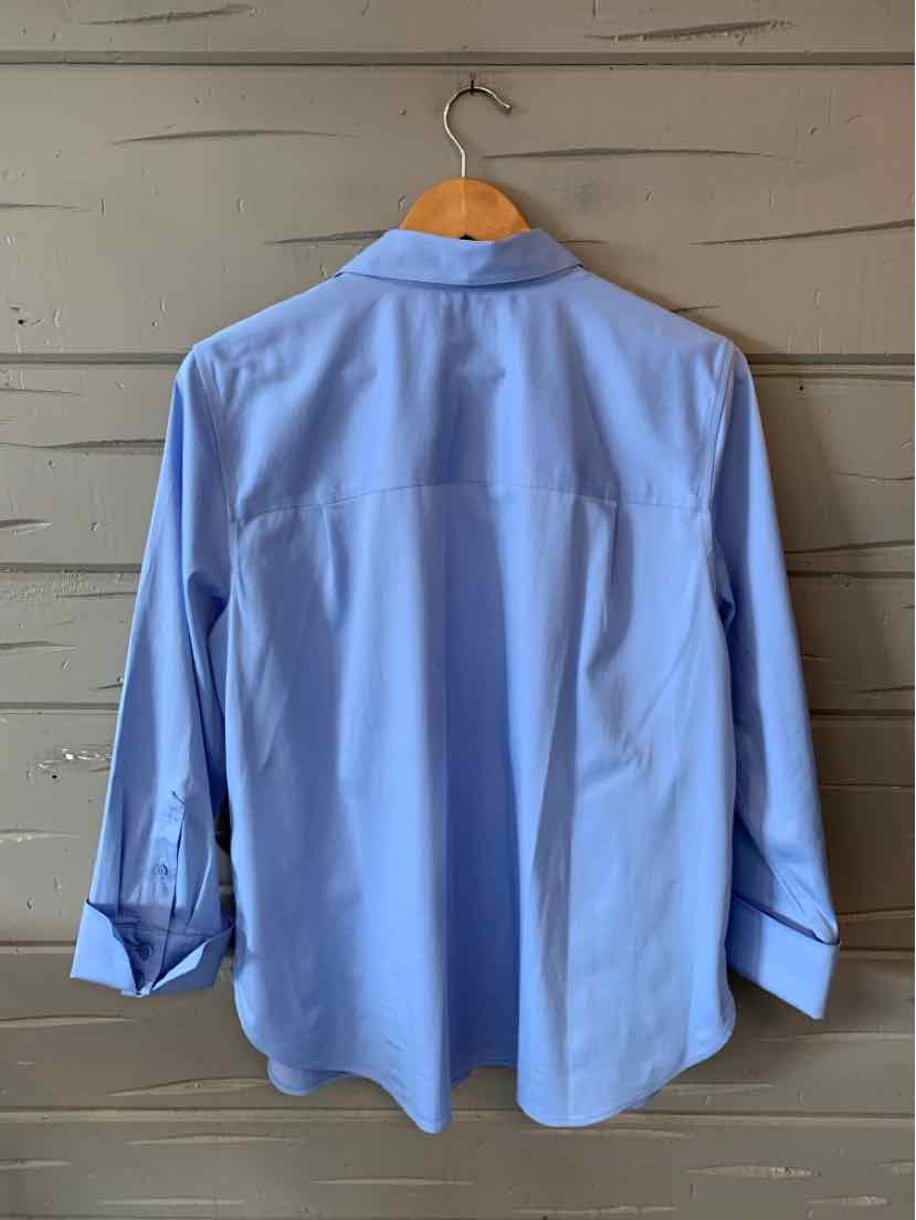 Light blue long-sleeve blouse with buttoned cuffs and a classic collar hanging on wooden hanger.