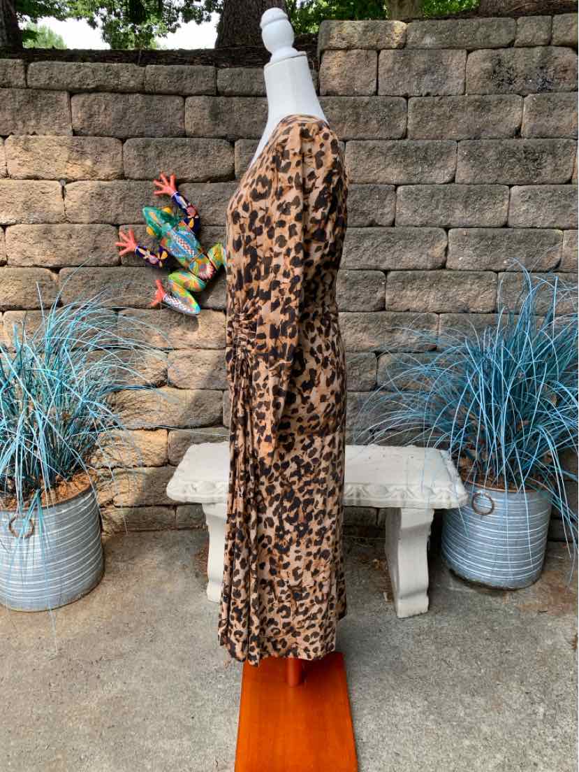 Mid-length leopard print dress with long sleeves and a relaxed fit on a mannequin outdoors.