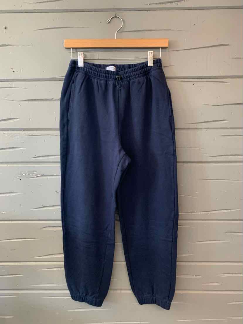 Navy blue women’s jogger pants with an elastic waistband, drawstring, and tapered cuffs.