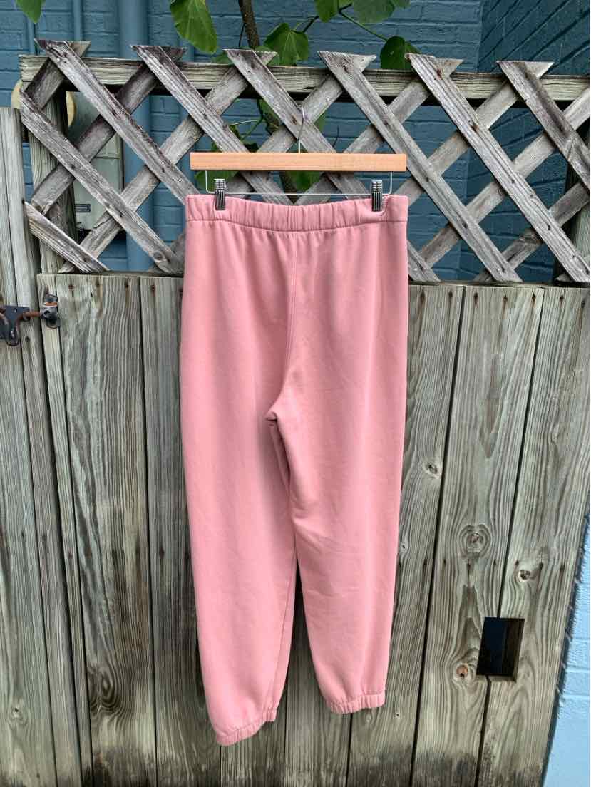 Soft pink fleece sweatpants with elastic waistband and cuffs, medium size.