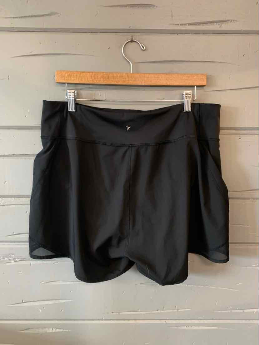 Black athletic shorts with wide waistband and front pockets, made from smooth fabric, size large.