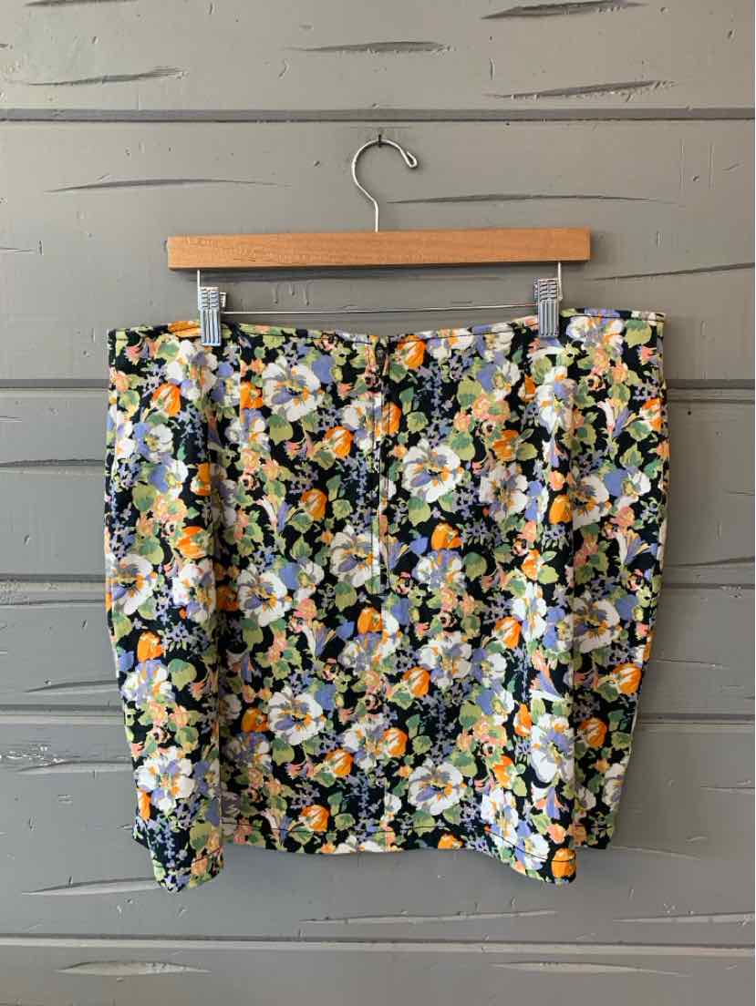 Floral mini skirt with vibrant multicolor print, fitted silhouette, and straight hem.