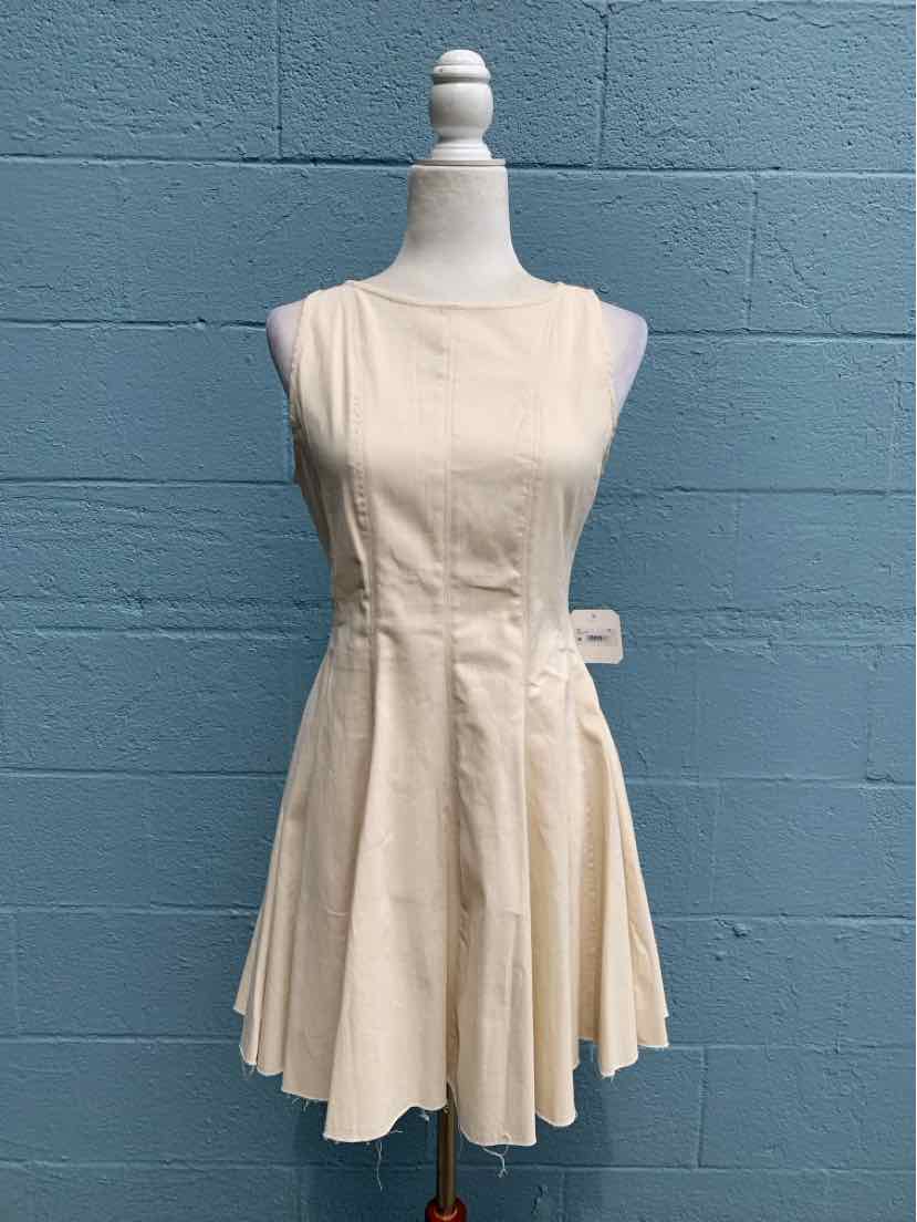 Cream-colored sleeveless dress with fitted bodice and flared skirt on mannequin against blue wall.