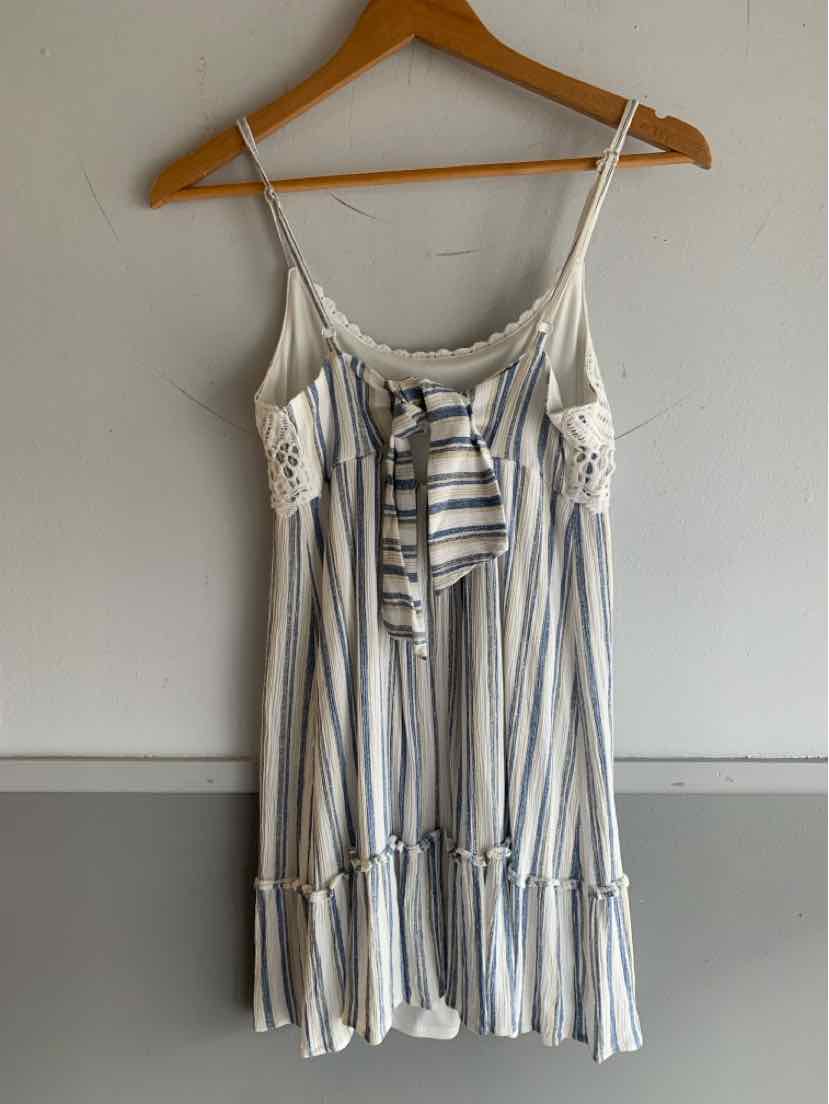 Blue and white striped spaghetti strap dress with front tie and ruffle hem in XS size.