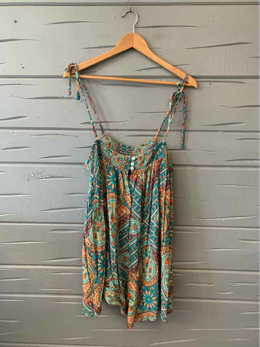 Boho-style sleeveless dress with teal, orange, and white abstract print, adjustable shoulder ties.
