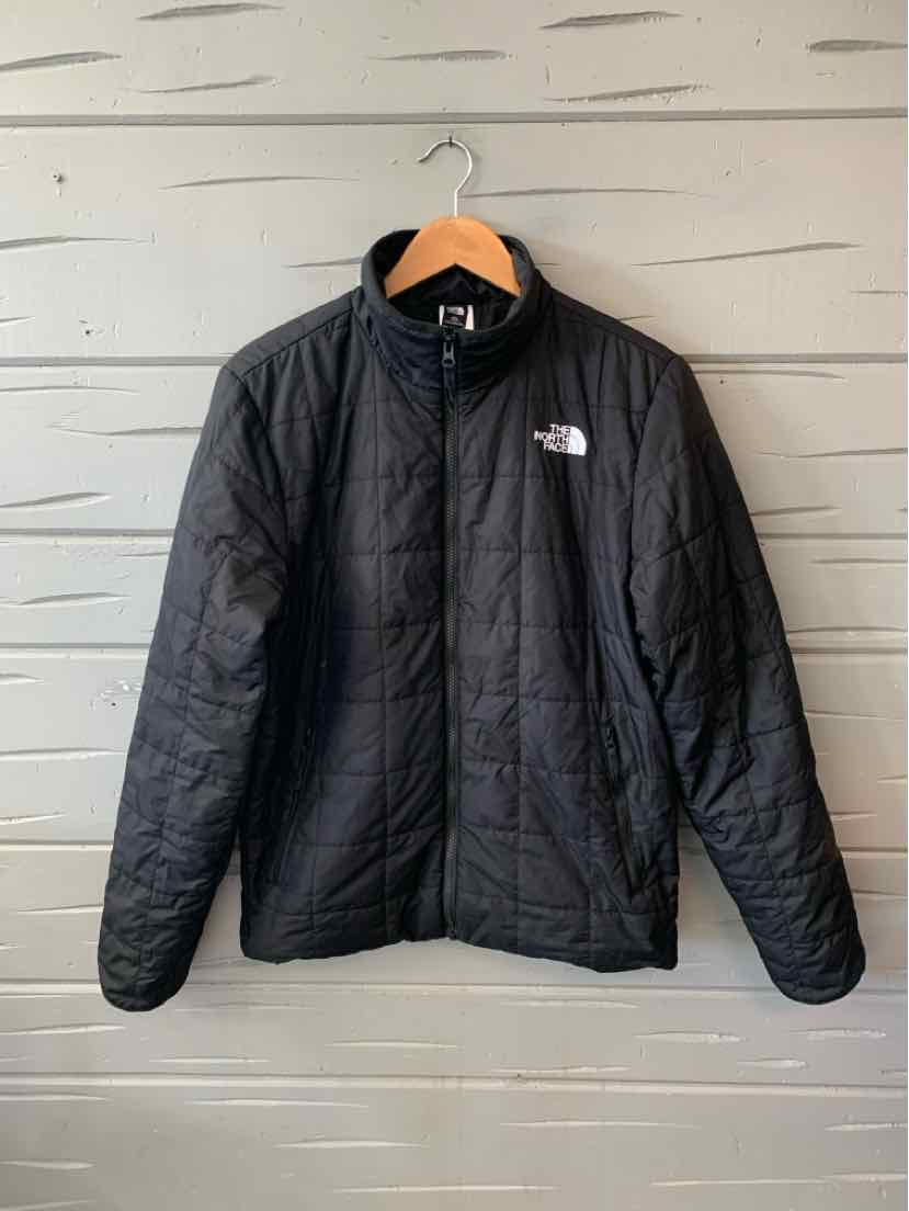 Black lightweight quilted jacket with full zipper and white The North Face logo on chest.