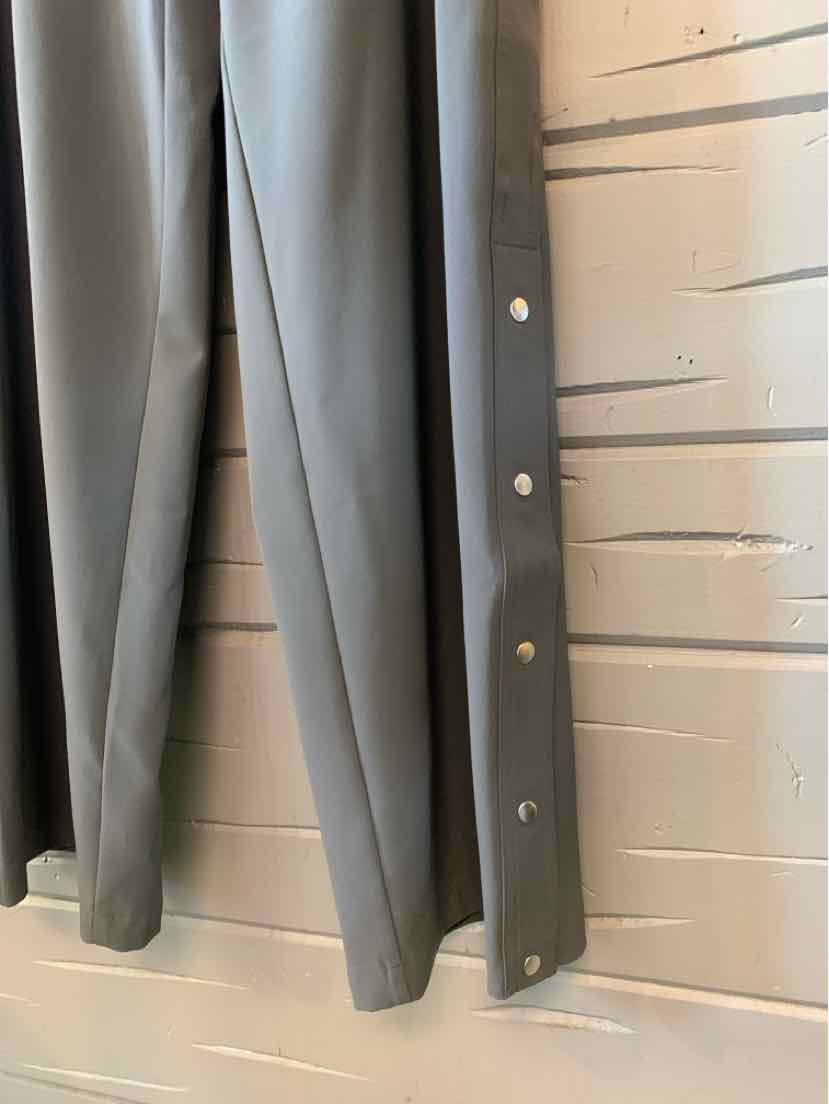 Gray Athleta athletic pants hanging straight, with a smooth, lightweight fabric and relaxed legs.