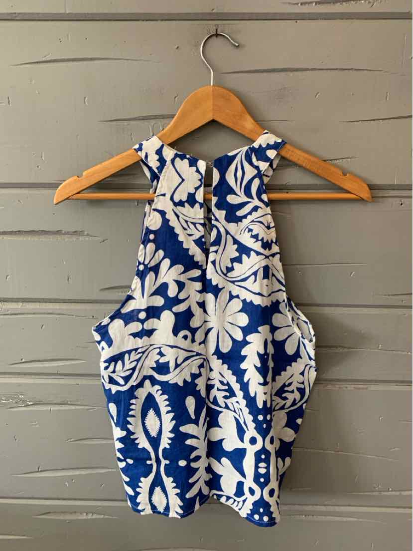 Blue and white floral sleeveless crop top with high neckline and keyhole back detail.