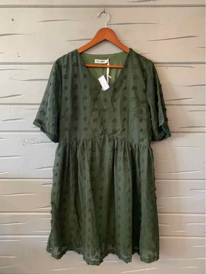 Dark olive green short-sleeve dress with a V-neck, gathered waist, and textured sheer fabric.