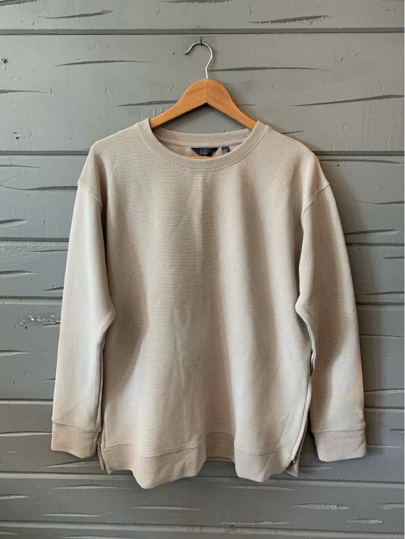 Beige long-sleeve crewneck sweatshirt with ribbed cuffs and hem, medium size.