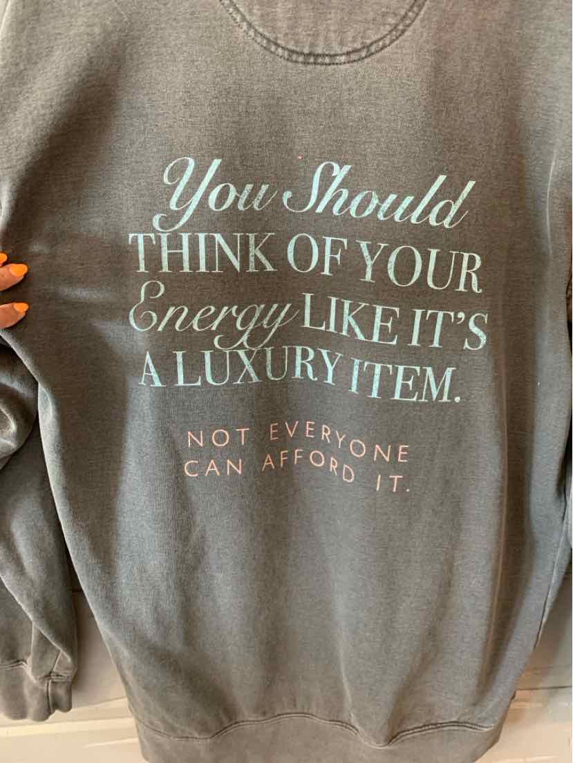 Brown long-sleeve sweatshirt with white and beige motivational text on the back in mixed fonts.