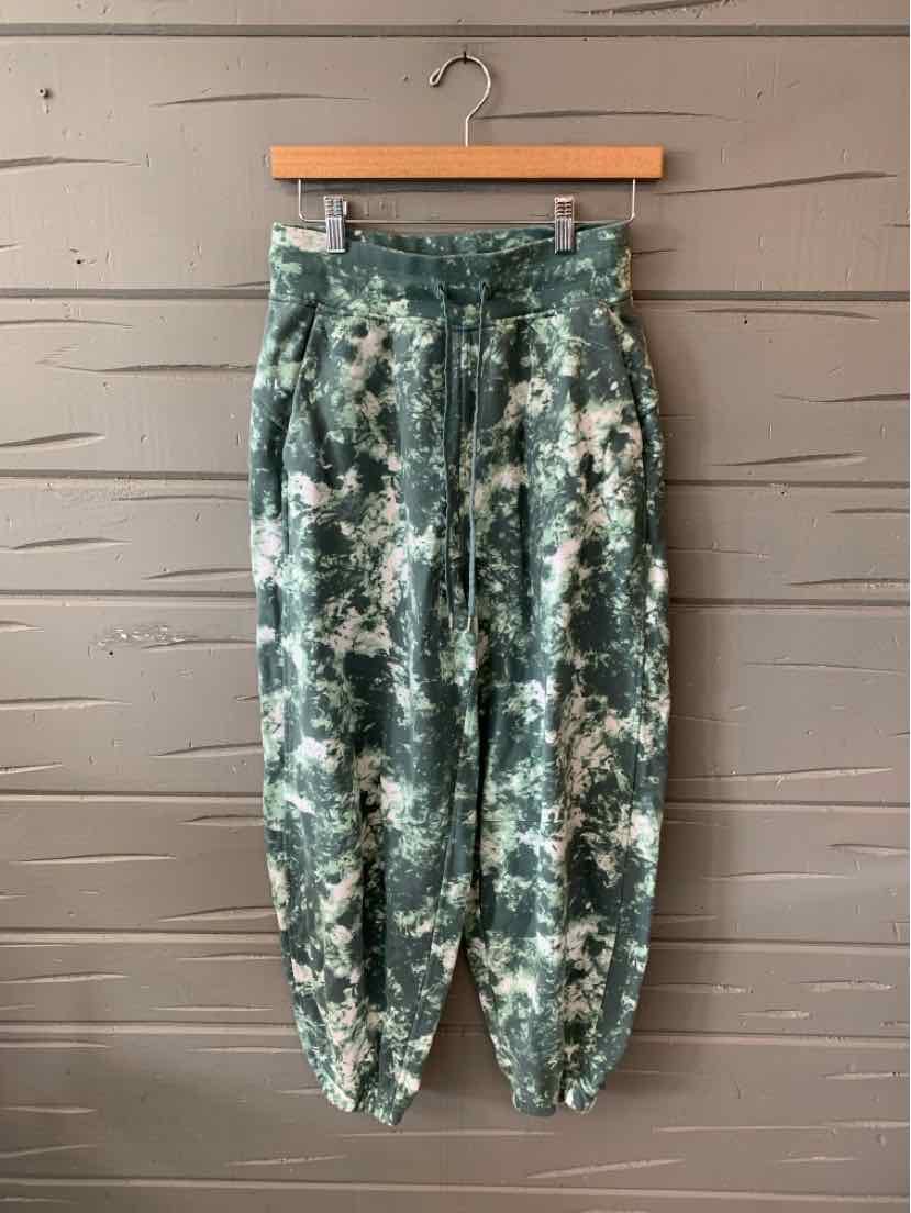 Green and white tie-dyed jogger pants with elastic cuffs and waistband, size 6.