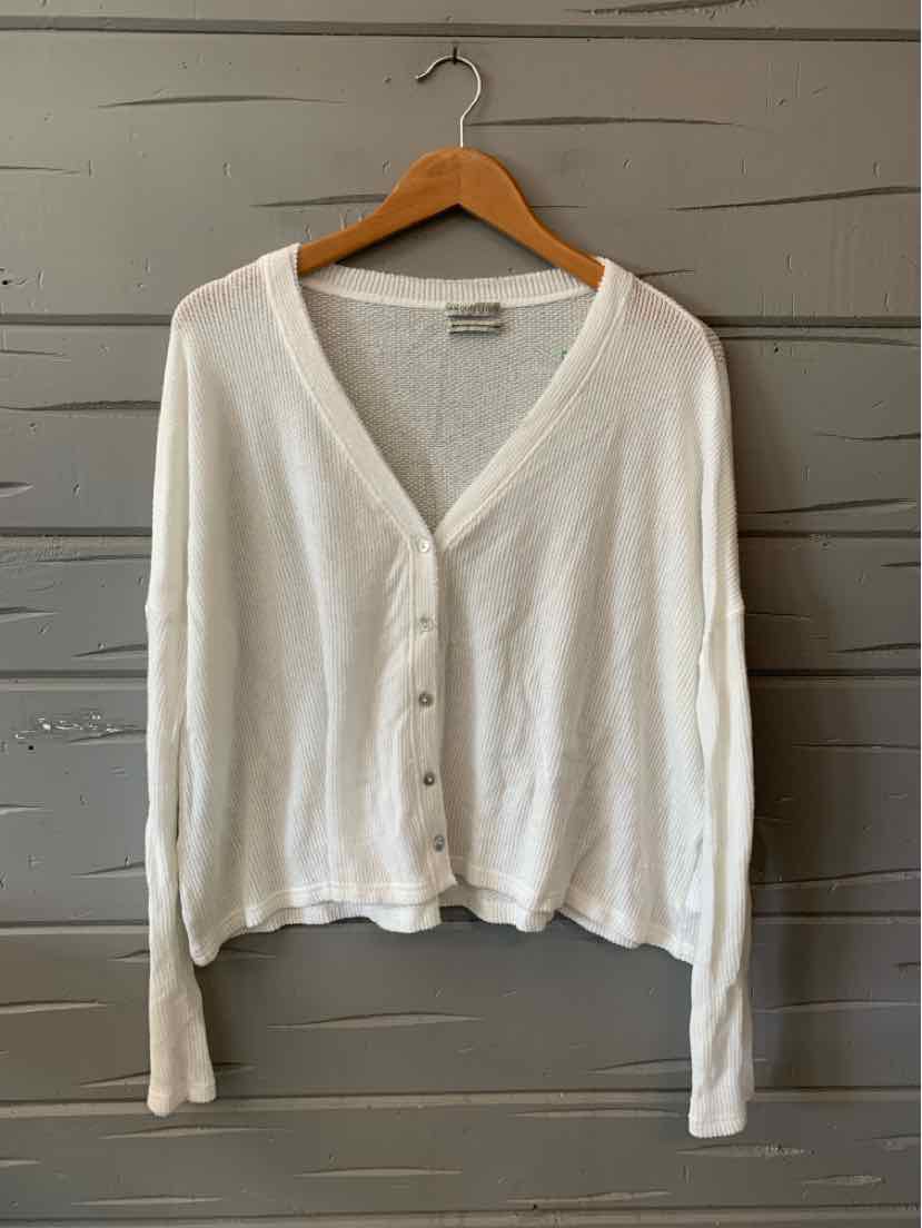 White lightweight long-sleeve button-up cardigan with V-neck and ribbed cuffs on wooden hanger.