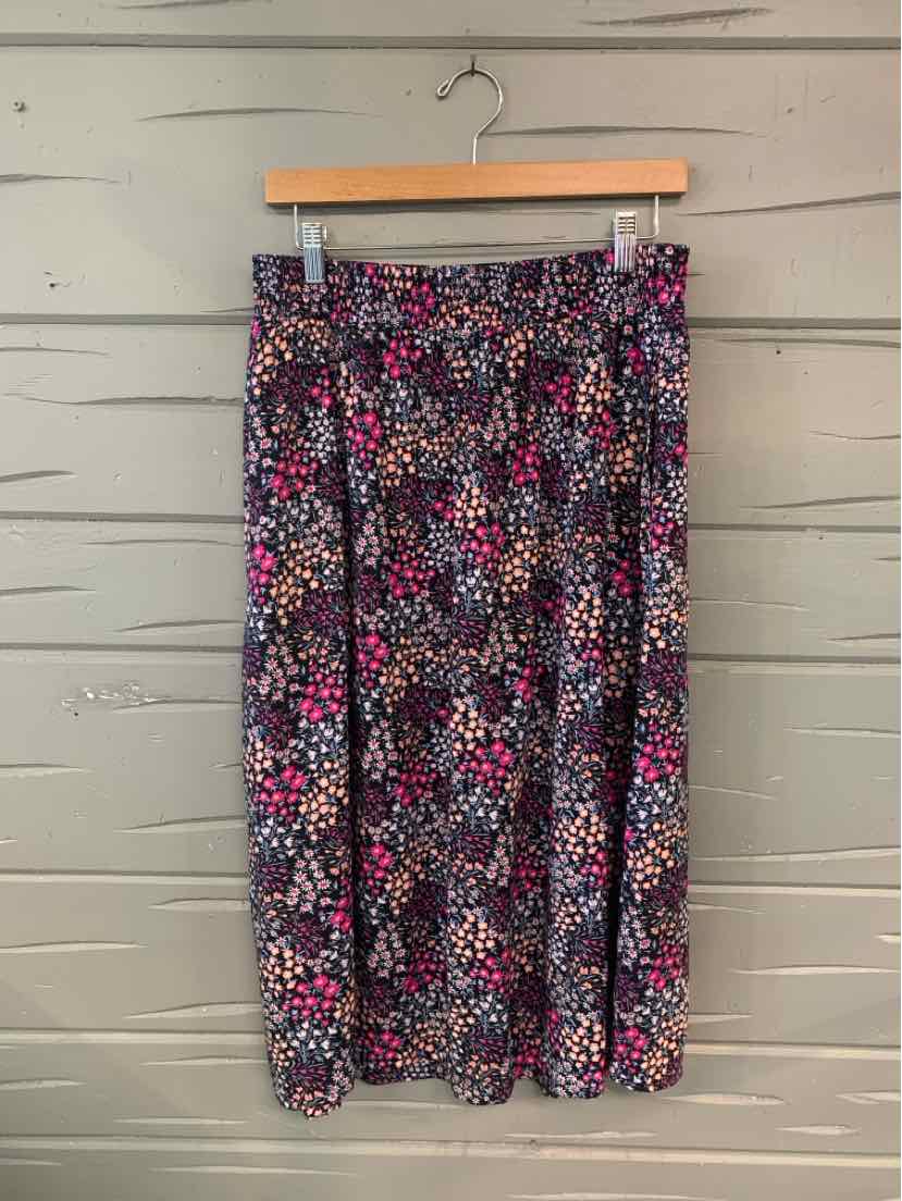 Floral-print midi skirt in navy with pink, white, and purple blossoms, gathered waistband.