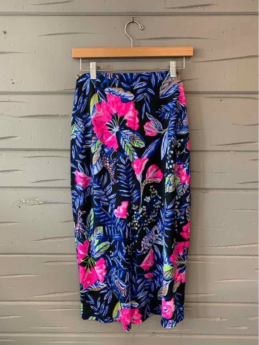 Navy blue tropical skirt with bright pink and green floral print, lightweight fabric, midi length.