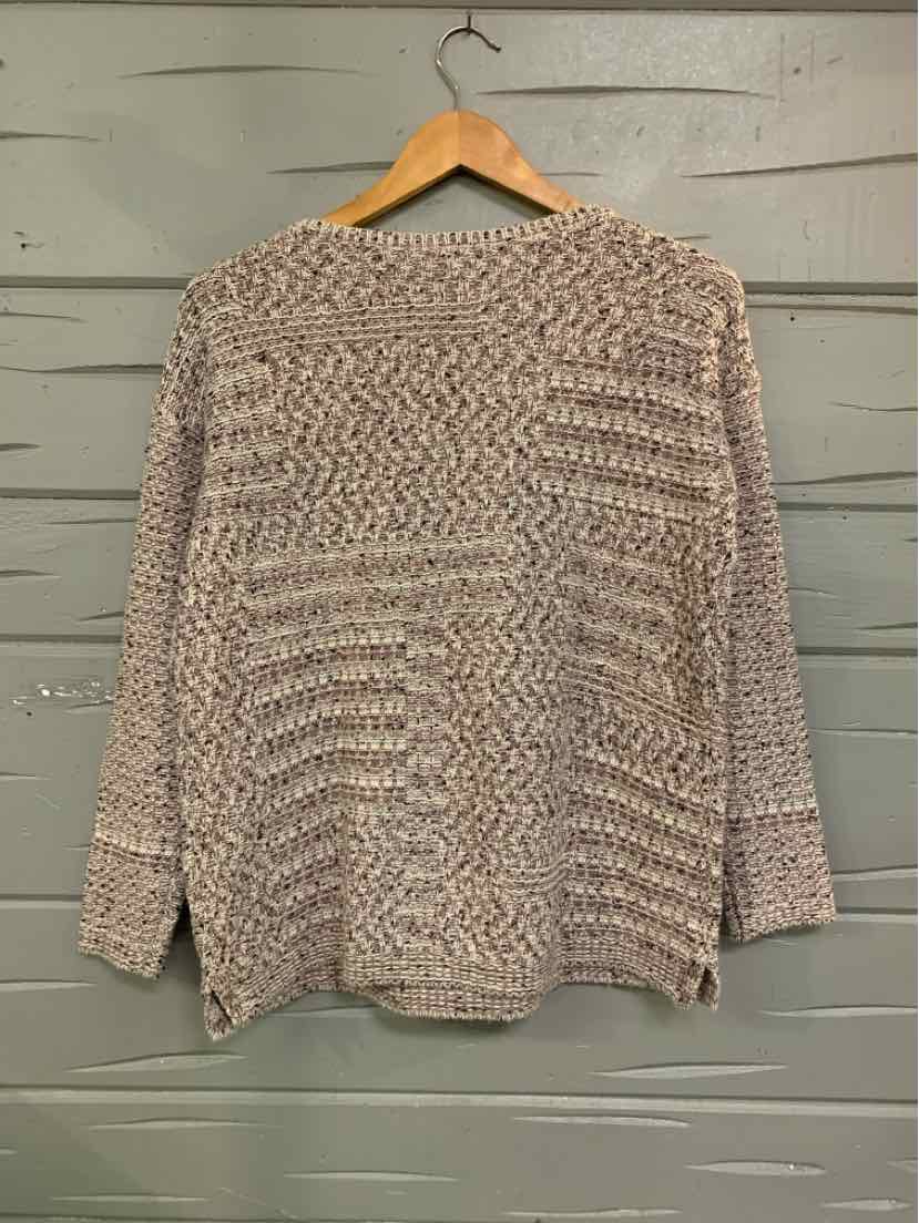 Light beige and cream tweed knit sweater with long sleeves and a relaxed fit on wooden hanger.